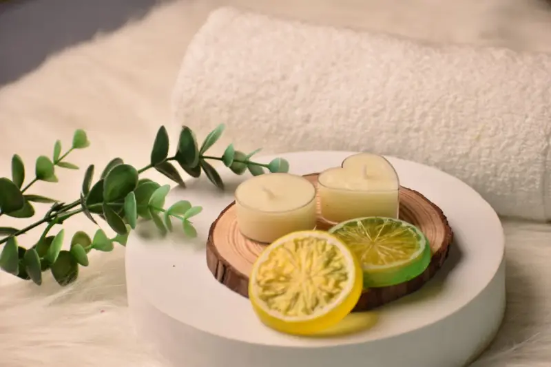 Spa still life with candles, citrus slices, a towel and eucalyptus