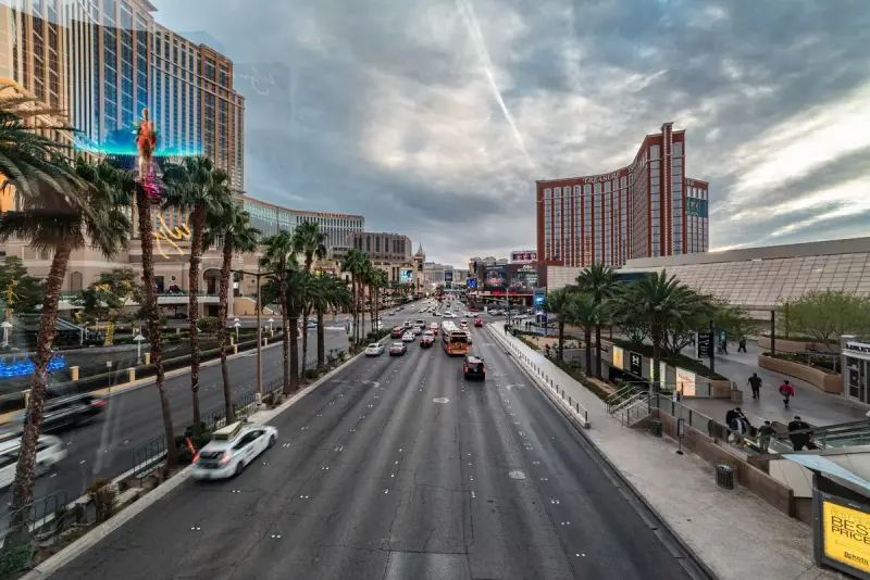 Las Vegas Strip by day with traffic, palm trees and resort towers