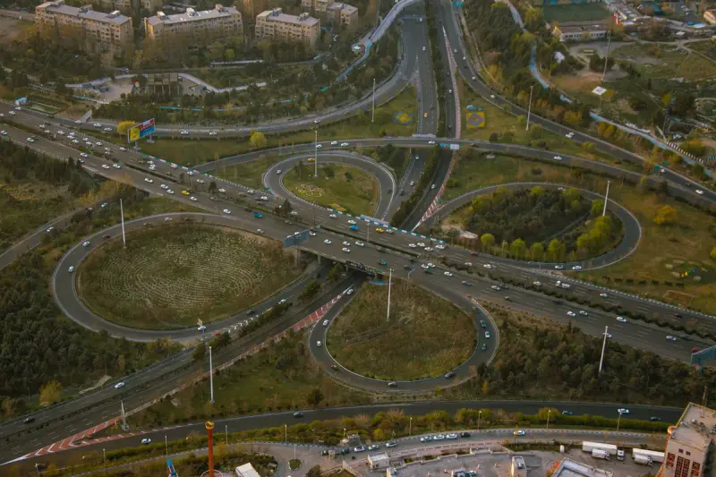 Aerial view of a multilevel highway interchange with traffic flowing in daylight