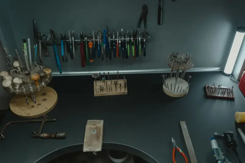 Jeweler workstation with pliers, files and bench tools laid out neatly