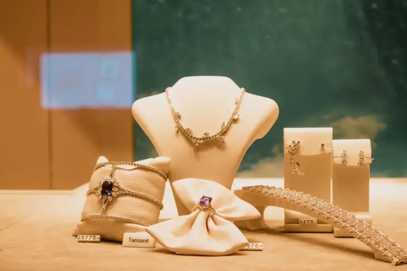 Necklaces and rings with blue tanzanite and diamonds displayed in a jewelry case