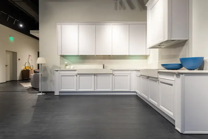 White shaker kitchen units displayed in a large furniture showroom
