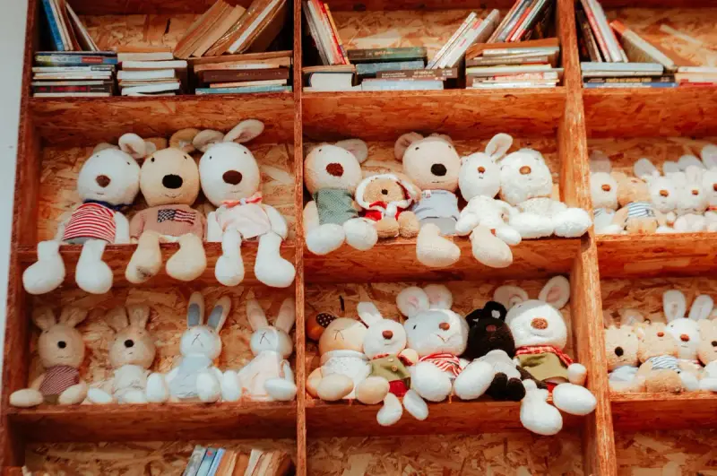 Wooden cubby shelves filled with plush bunnies and stacks of children's books