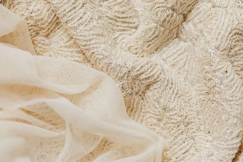 Close-up of beige lace beside a sheer fabric
