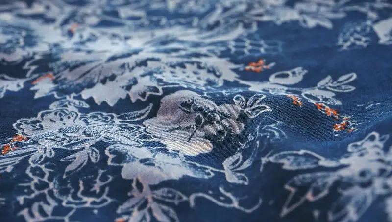 Blue fabric with a white floral print in close-up