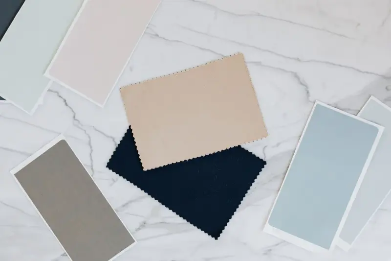 Fabric and color swatches laid out on a marble table