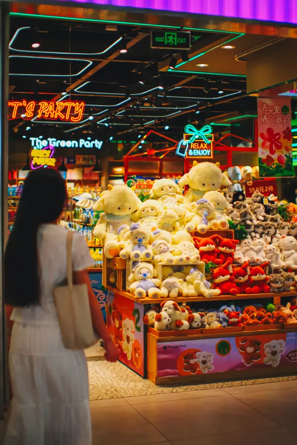 Colorful toy-store display with large plush figures and illuminated retail signage