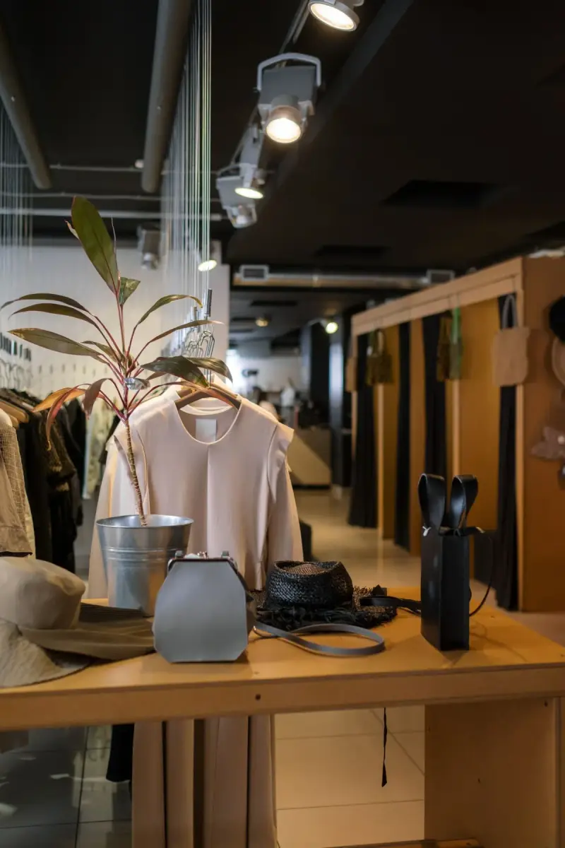 Clothing and accessories arranged on display fixtures inside a fashion store