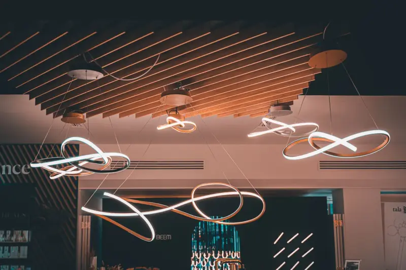 Spiral cluster of hanging globe lights suspended from a ceiling in a London interior