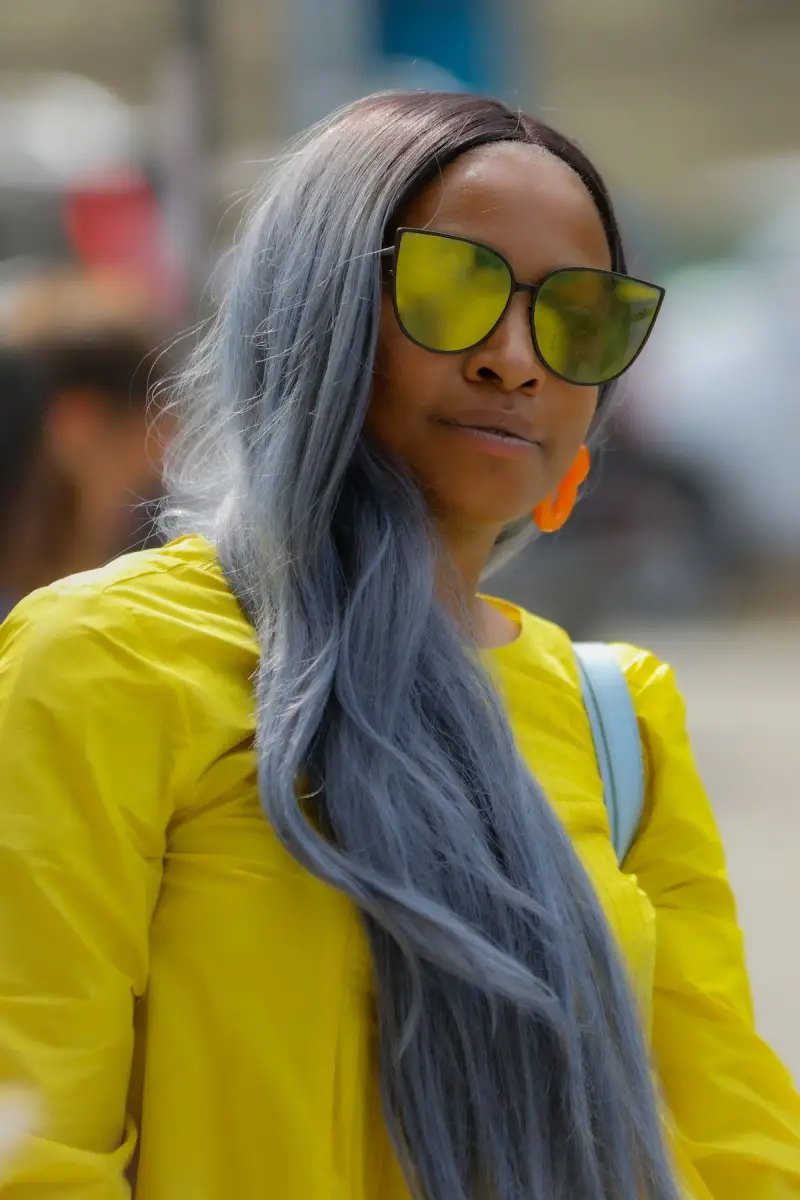 Woman with silver hair in oversized yellow mirrored sunglasses, New York street style