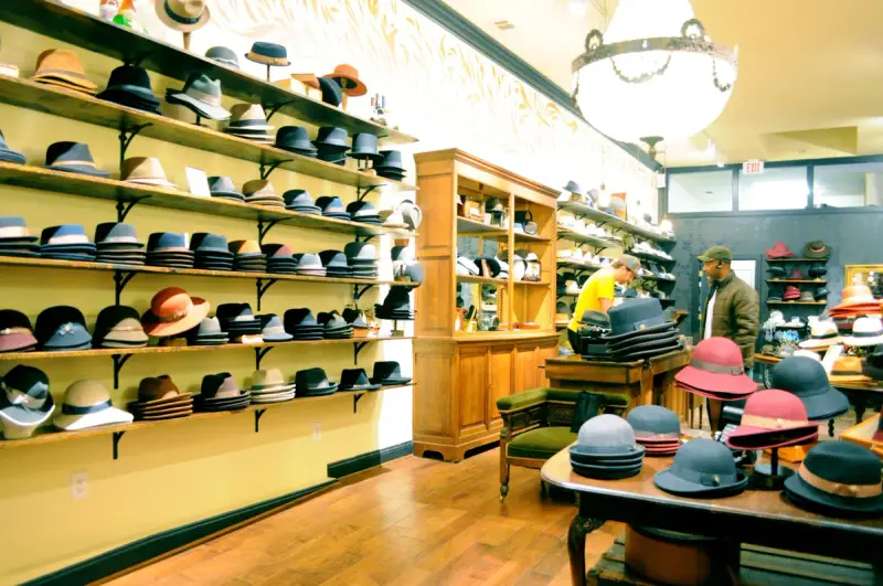 Hats displayed in the window and racks of a small hat shop in Berkeley