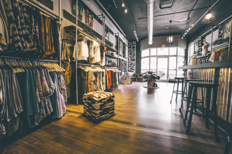 Boutique sales floor with clothing displays and a bar counter