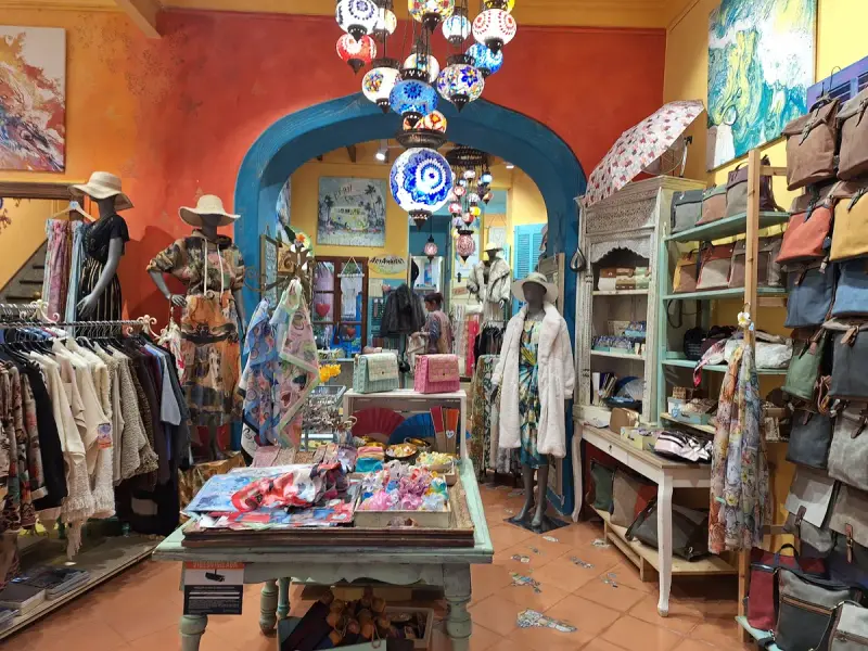Boutique interior with clothing rails and display furniture