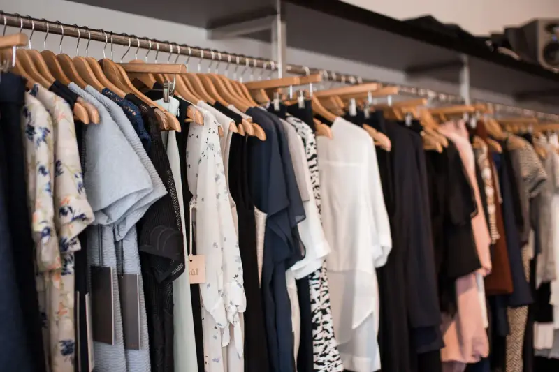 Colorful clothing on wooden hangers in a modern boutique