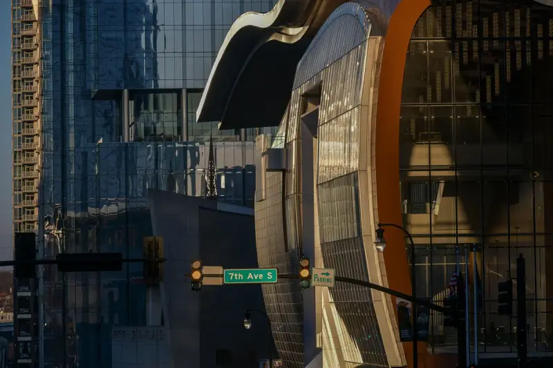 The curved glass and metal facade of Music City Center at 7th Avenue South, Nashville