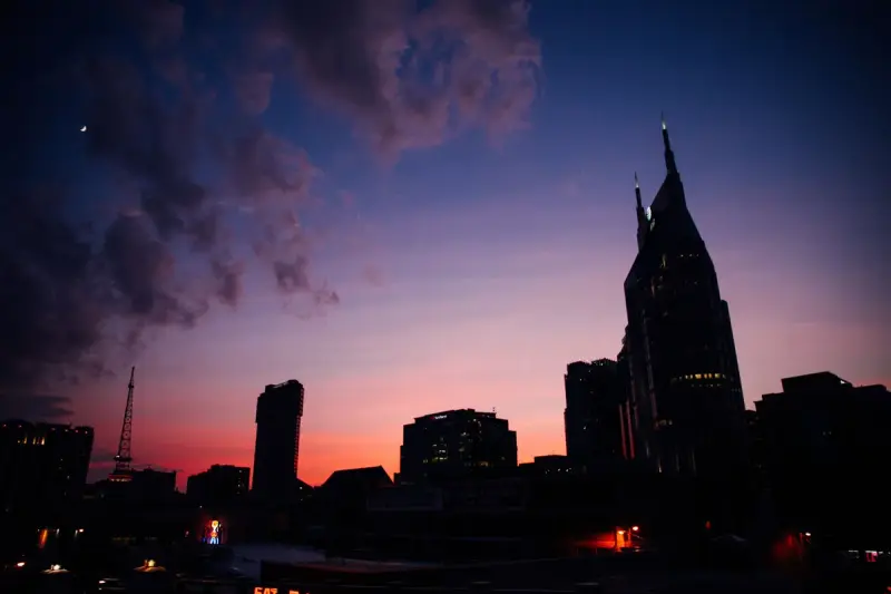 Nashville skyline silhouetted against a colorful twilight sky