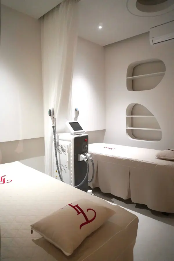 Modern spa room with treatment tables and equipment