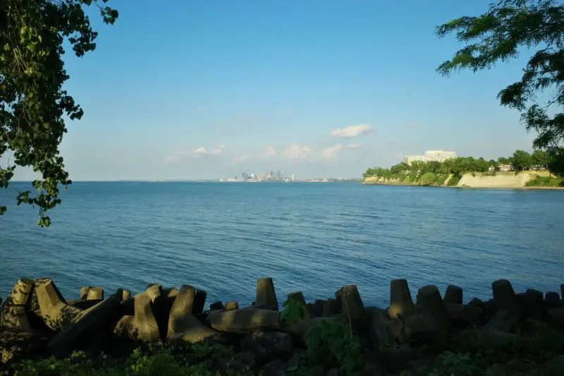 Downtown Cleveland skyline seen across Lake Erie from a lakeside park