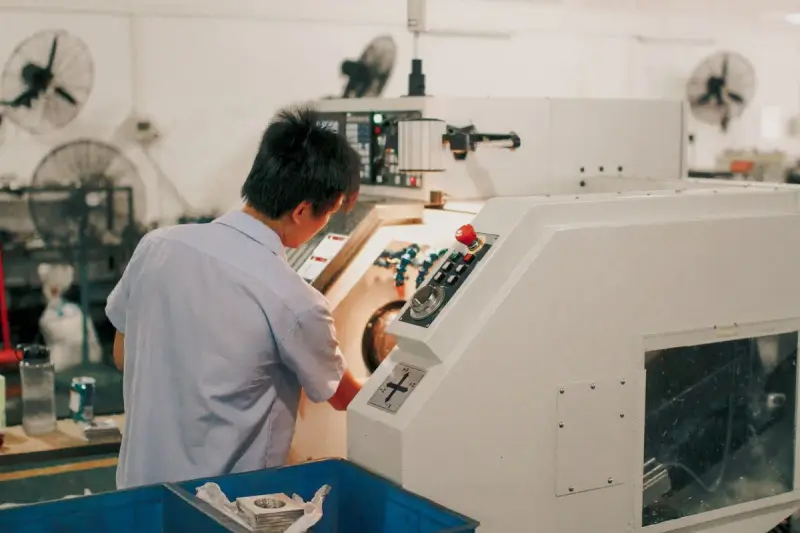 Worker focused on operating industrial machinery in a factory