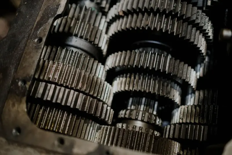 Rows of steel helical gears packed inside an open gearbox housing