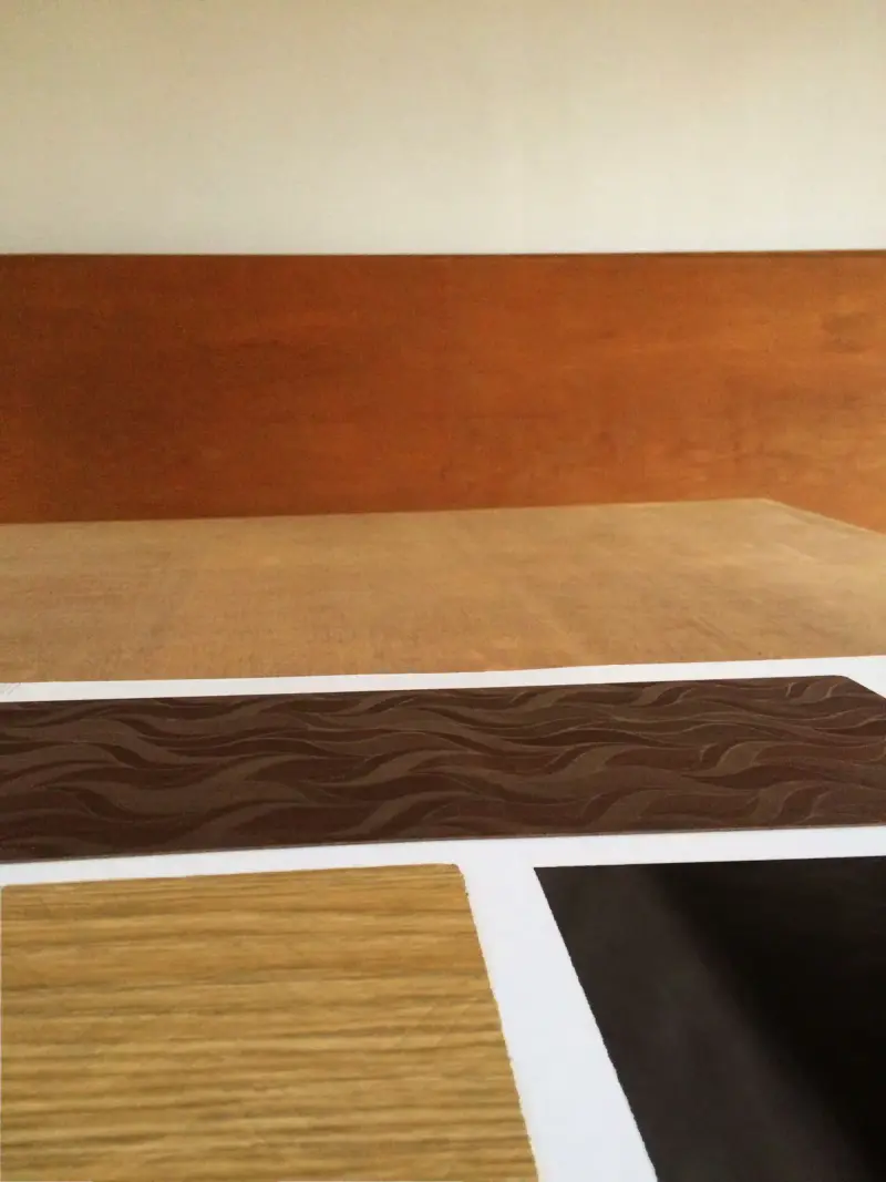Wooden laminate samples in different colors and textures on a table