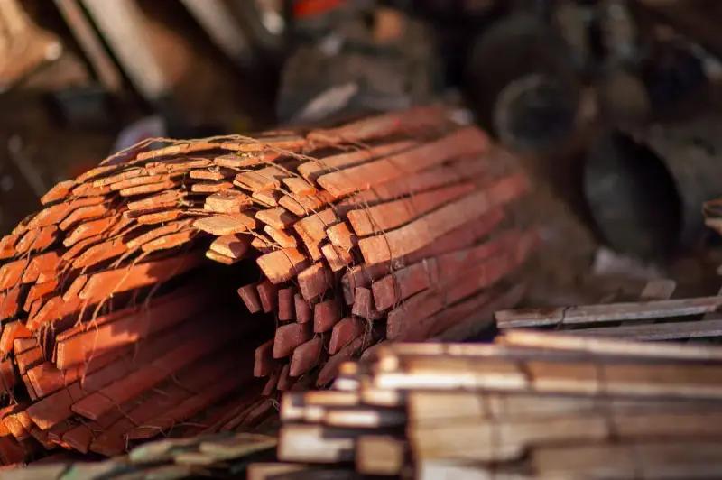 Stacked wooden planks in a dimly lit warehouse