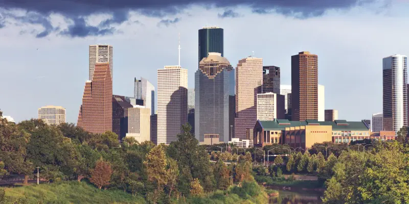 Downtown Houston skyline seen from the west over the trees of Buffalo Bayou