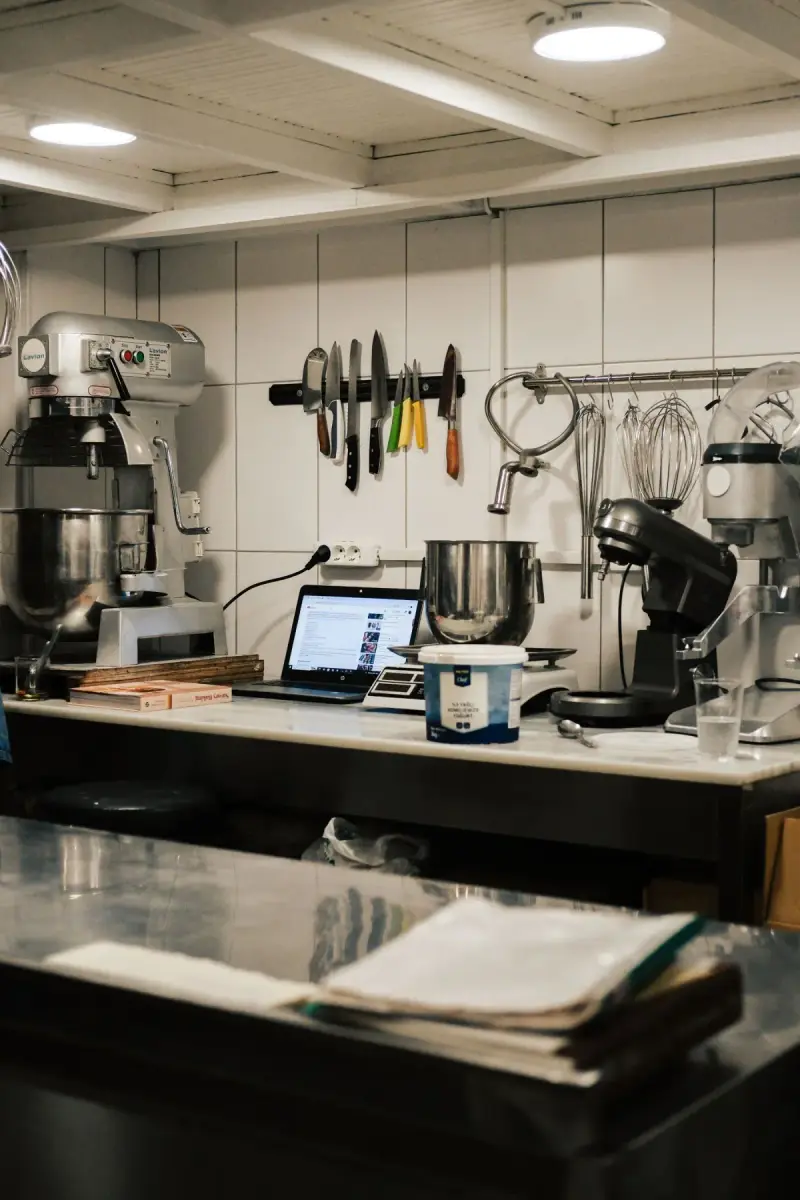 Commercial kitchen work surface with a mixer and preparation tools