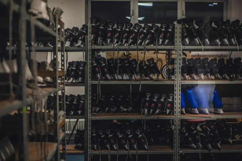 Shelves of boots stacked in rows inside a rental and retail shop