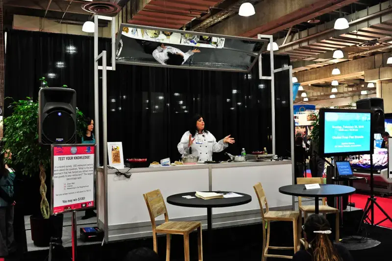 Chef presenting on the cooking demonstration stage at the International Restaurant & Foodservice Show of New York