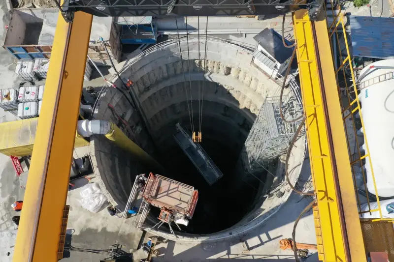 Deep circular launch shaft with cranes and equipment seen from above