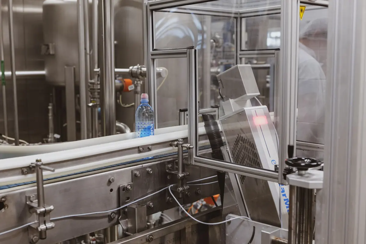 Plastic bottle moving along an automated production line in a modern factory
