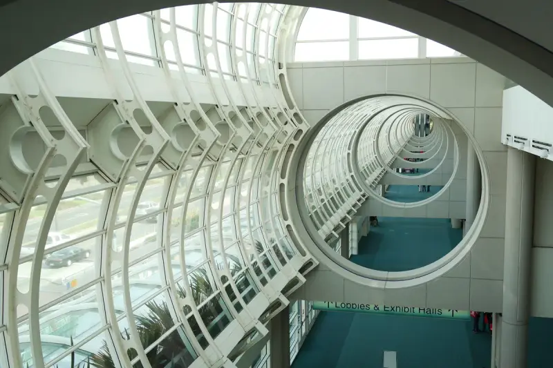 Curved white steel and glass arches framing the upper concourse of the San Diego Convention Center