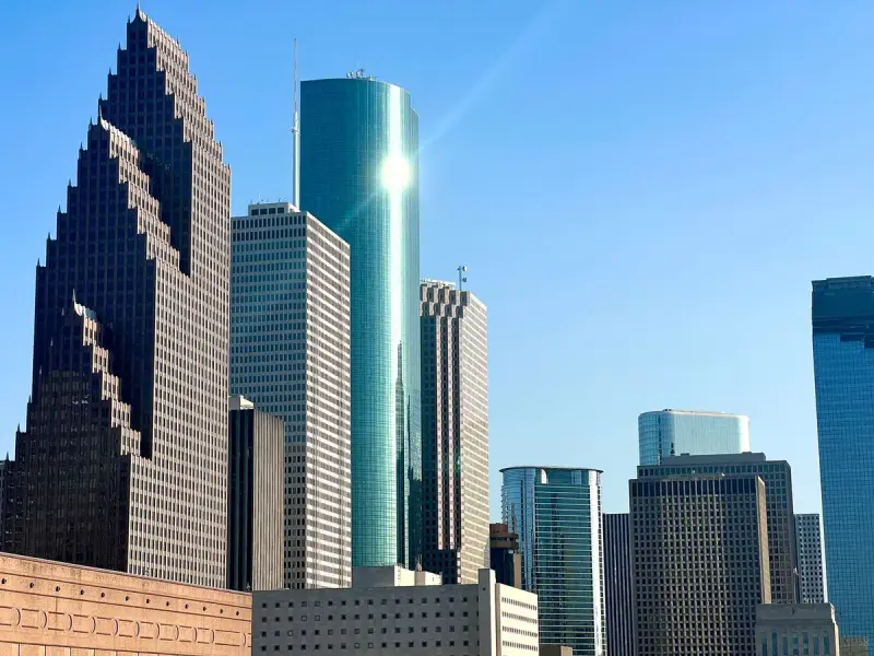 Downtown Houston skyscrapers under a clear blue sky
