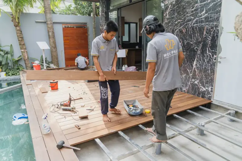 Carpenters installing wooden flooring at a building