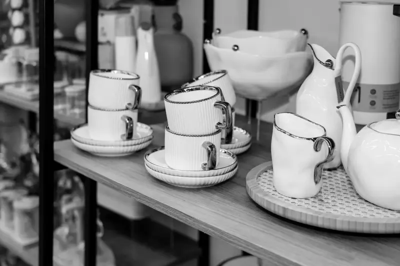Black and white porcelain cups and tableware arranged in a store display