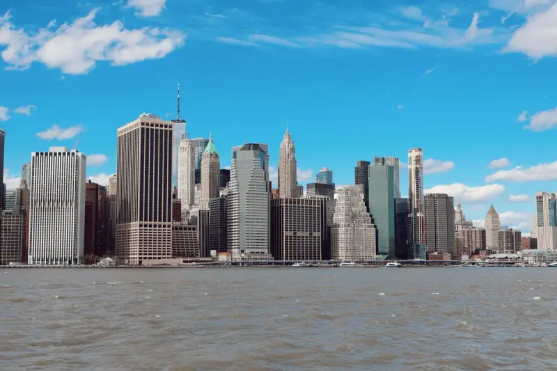 New York City skyline of Manhattan skyscrapers under a clear blue sky