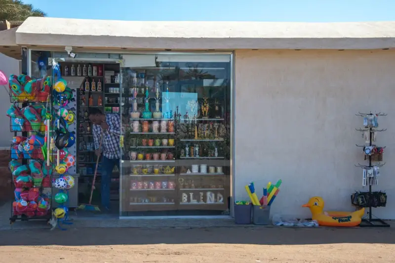 Small beach souvenir shop with inflatable balls, toys and shelves of gifts outside