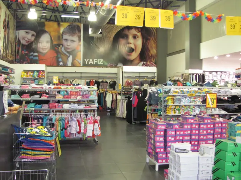 Interior of a clothing store with stocked shelves and racks
