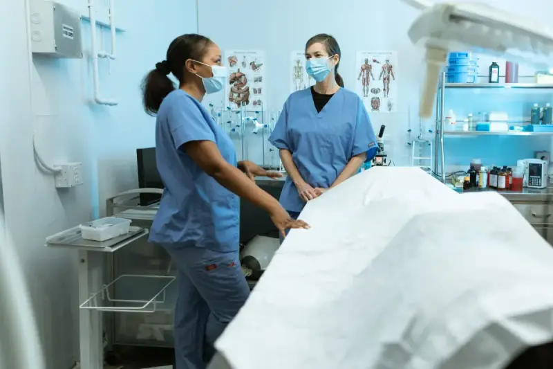 Two female nursing professionals in a clinical discussion