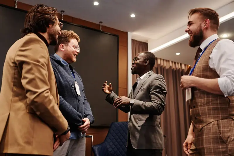 Business colleagues in suits talking during a meeting break
