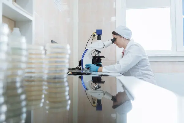 Woman using a microscope in a laboratory