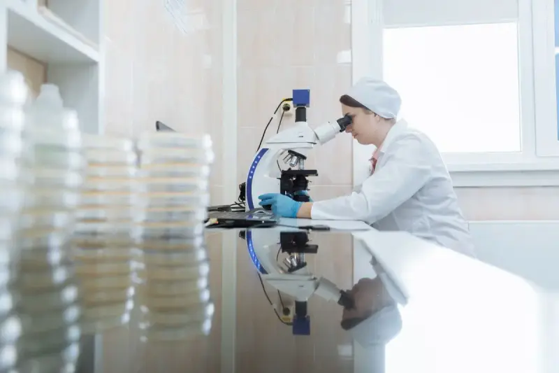 Woman using a microscope in a laboratory