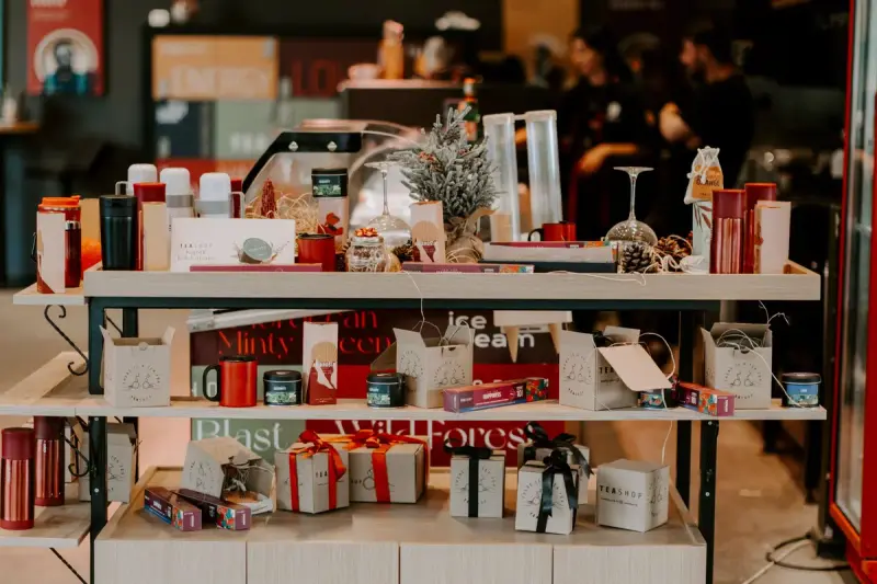 Holiday display of wrapped gifts, ornaments and festive packaging on a shop table