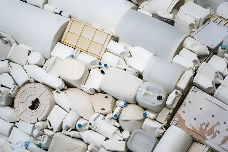 Pile of white plastic containers, jugs and housings sorted for recycling