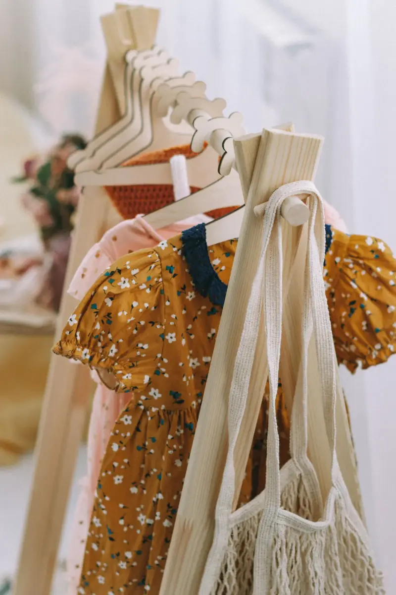 Children's floral dresses on wooden hangers