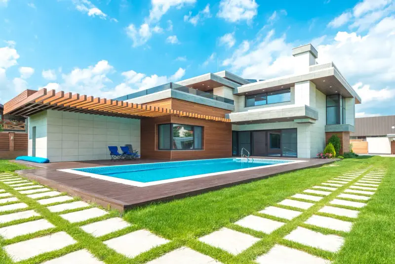 Modern house with a long pool, wooden deck and stepping-stone lawn