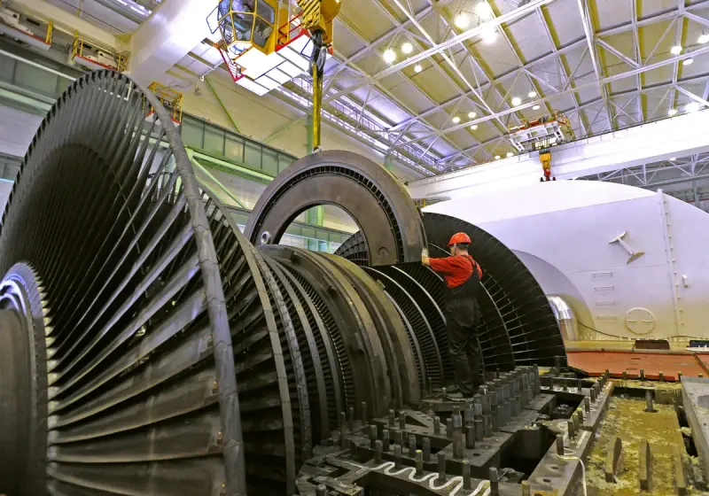 Technicians maintaining the open low pressure section of a large steam turbine