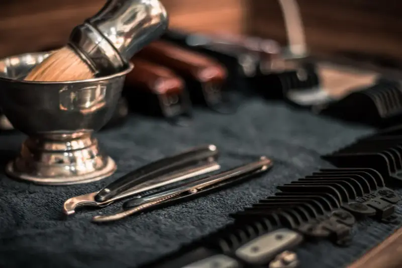Barber razors and combs lined up neatly on a counter