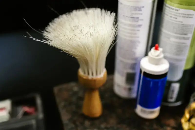 Barber neck duster brush with a wooden handle in a barbershop